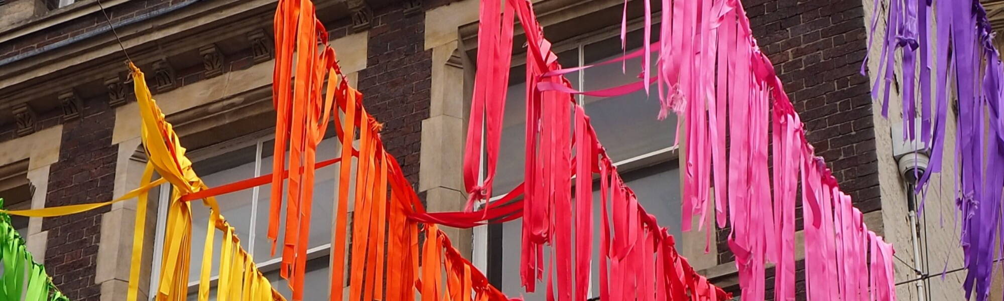 Derby Cathedral in England with joyful art display of ribbons and flags